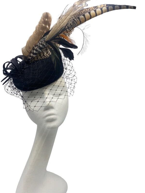 Black felt headpiece with a stunning face veiling and feather detail to finish.